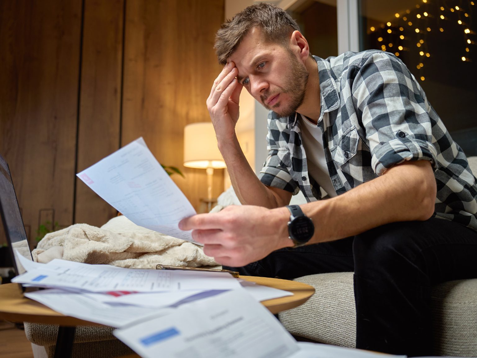 Waynesville NC homeowner reviewing mortgage payments to avoid foreclosure